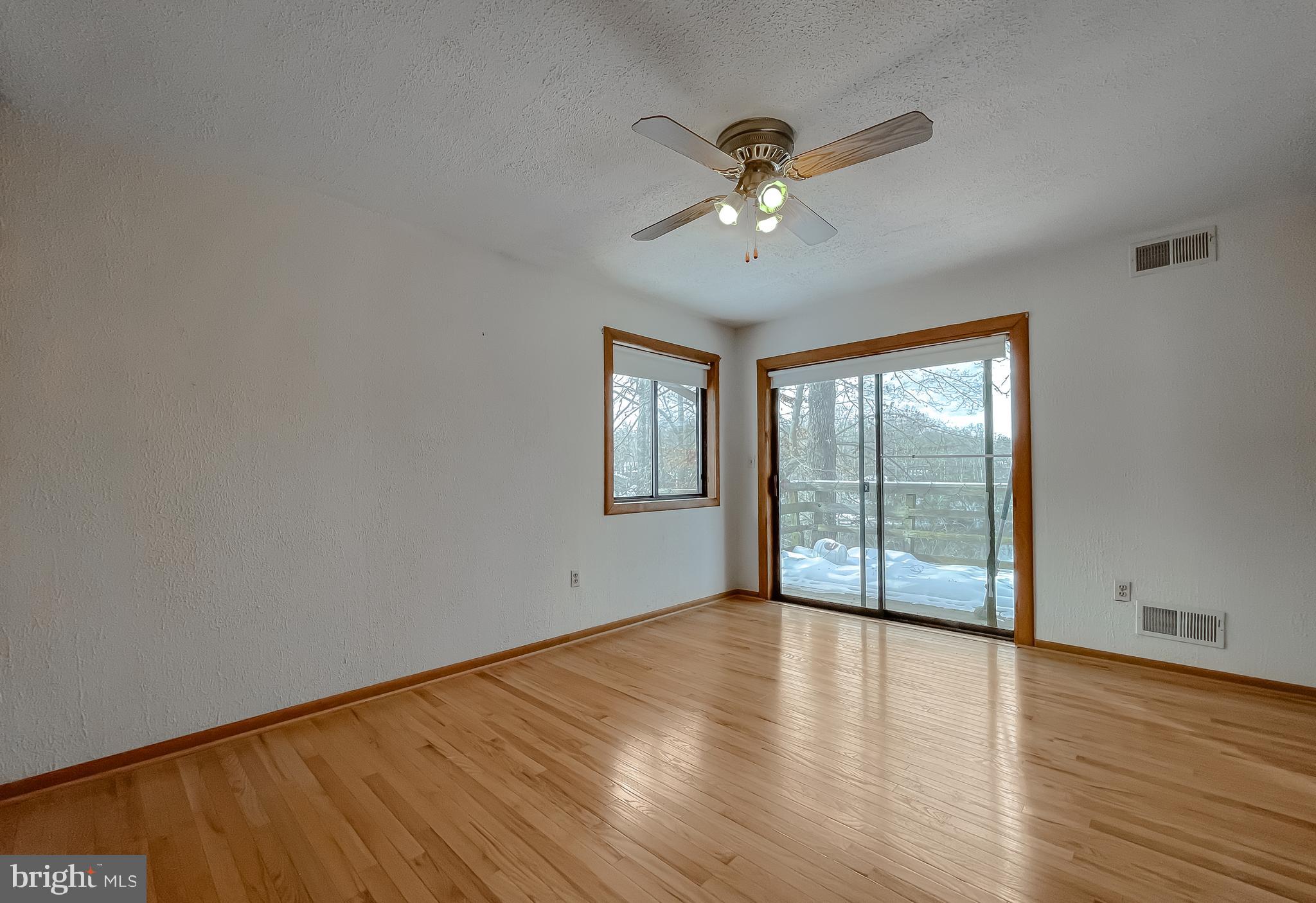 11525 Palo Alto Road Lusby, MD 20657 - Photo 44 of 74 a view of an empty room with wooden floor and a window