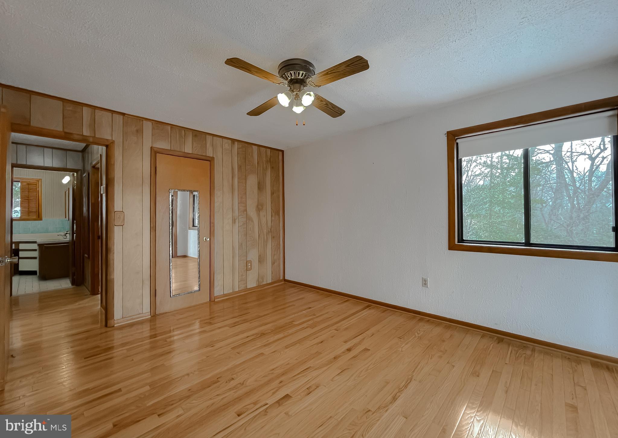 11525 Palo Alto Road Lusby, MD 20657 - Photo 45 of 74 a view of empty room with wooden floor and fan