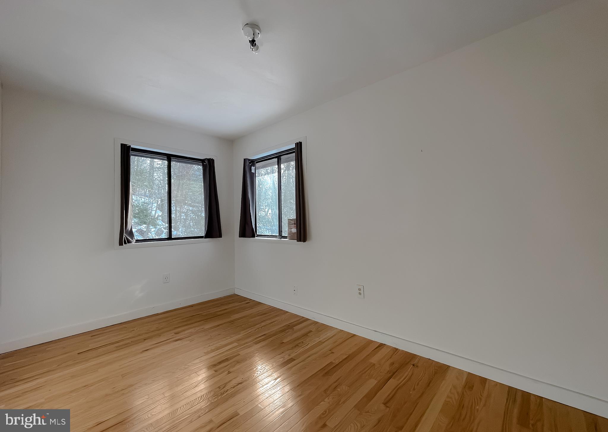 11525 Palo Alto Road Lusby, MD 20657 - Photo 50 of 74 a view of empty room with wooden floor and fan