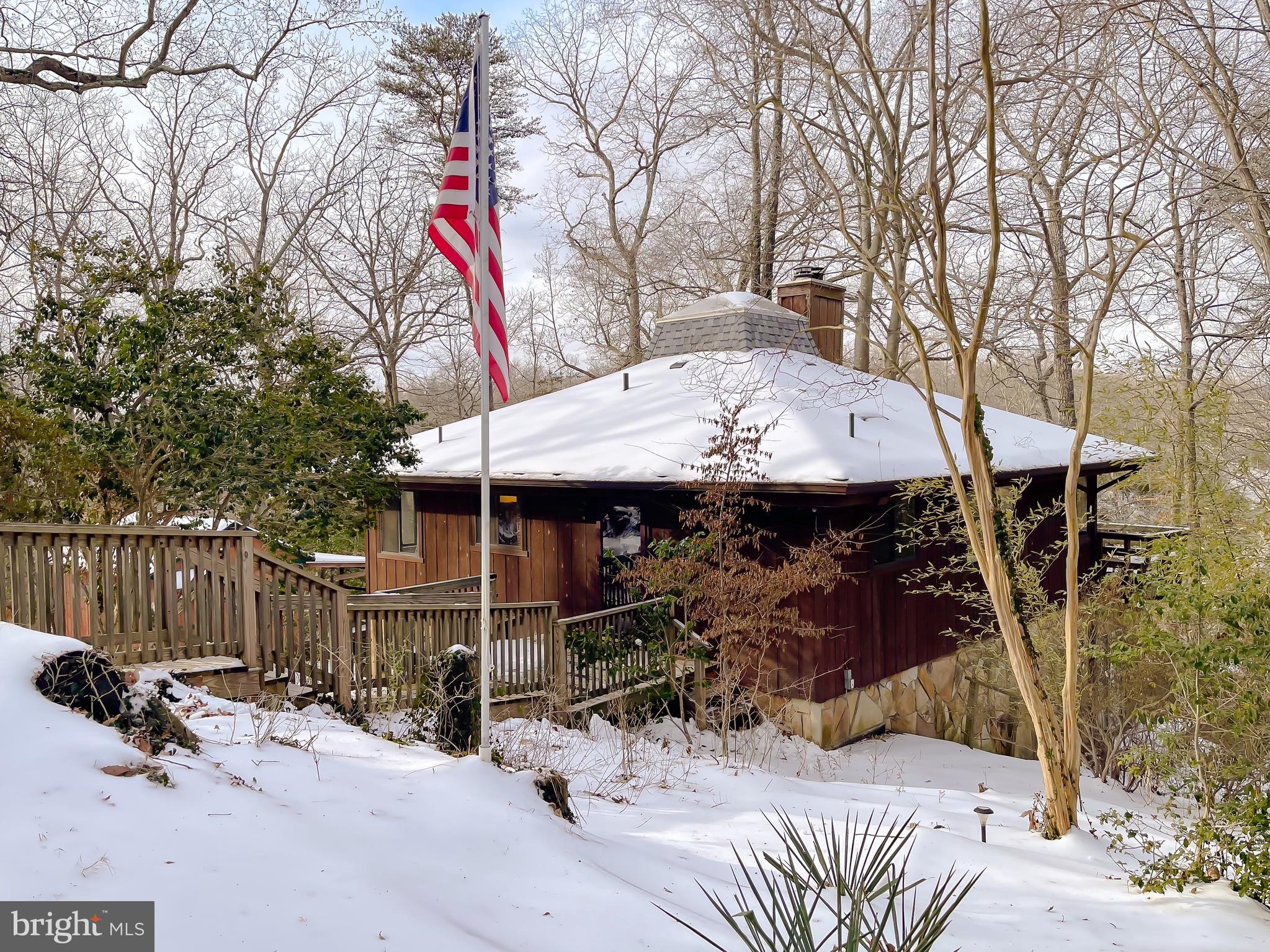 11525 Palo Alto Road Lusby, MD 20657 - Photo 72 of 74 a view of a patio with table and chairs with wooden fence and floor