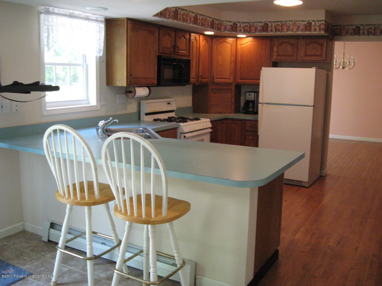 112 Ridgeview Drive Scranton, PA 18504 - Photo 3 of 15 a kitchen with stainless steel appliances a dining table chairs and a refrigerator