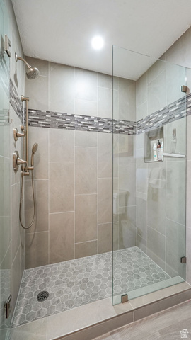 1364 Still Water Drive, Unit R2012 Heber City, UT 84032 - Photo 20 of 30 Walk-in shower featuring a frameless glass enclosure, a built-in shower niche, and a mosaic tile accent band