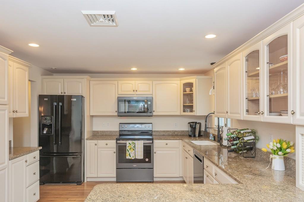 18 Harding Street Milford, MA 01757 - Photo 1 of 28 a kitchen with refrigerator and cabinets