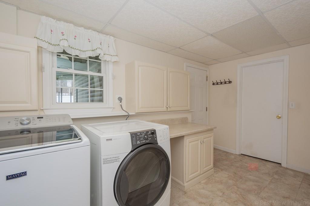 18 Harding Street Milford, MA 01757 - Photo 14 of 28 a view of a kitchen with cabinets washer and dryer