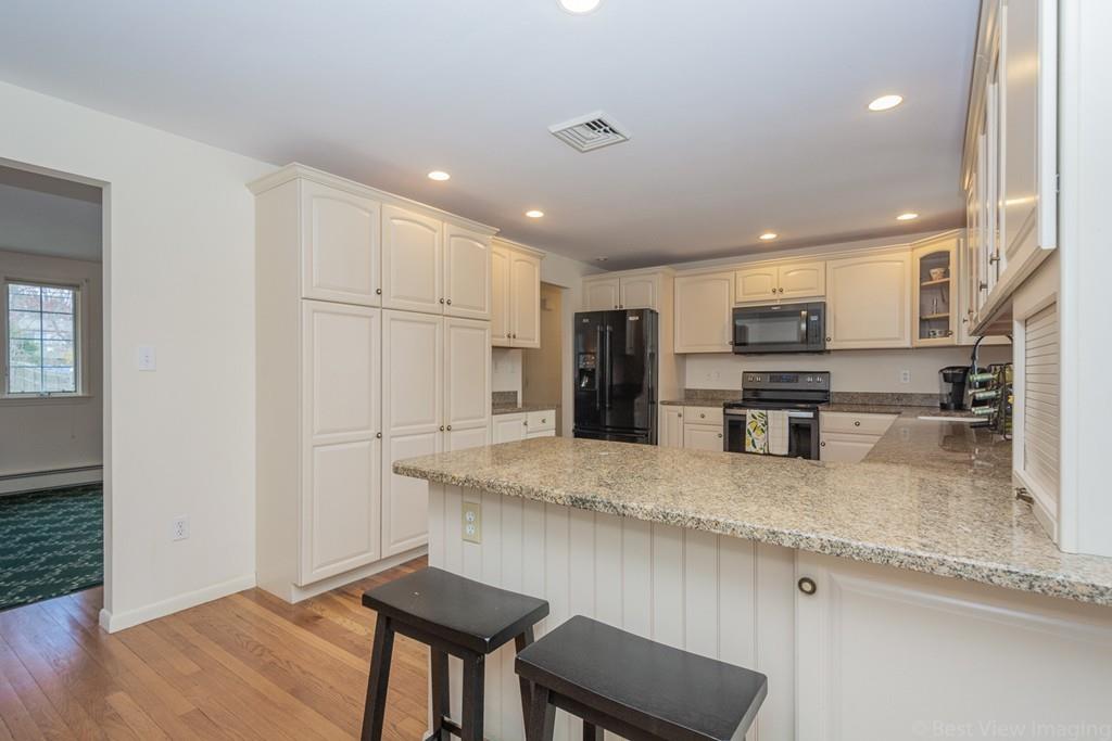 18 Harding Street Milford, MA 01757 - Photo 2 of 28 a kitchen with stainless steel appliances granite countertop a sink refrigerator and cabinets