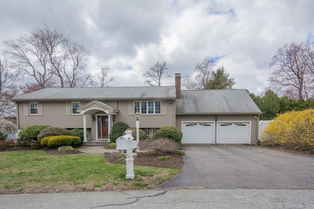 18 Harding Street Milford, MA 01757 - Photo 23 of 28 a front view of a house with a garden and plants