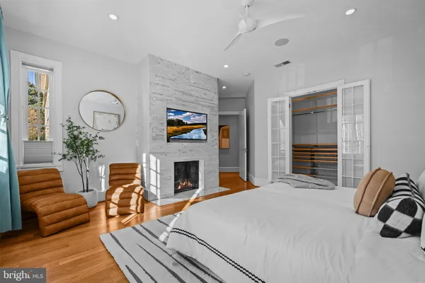 a bedroom with furniture and a fireplace
