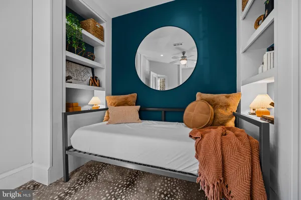 a bedroom with a bed and a painting on the wall