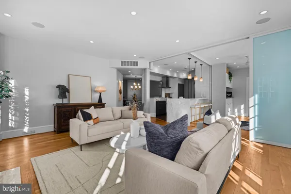 a living room with furniture and wooden floor