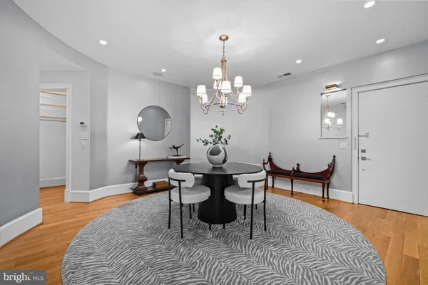 a living room with furniture a chandelier and a rug