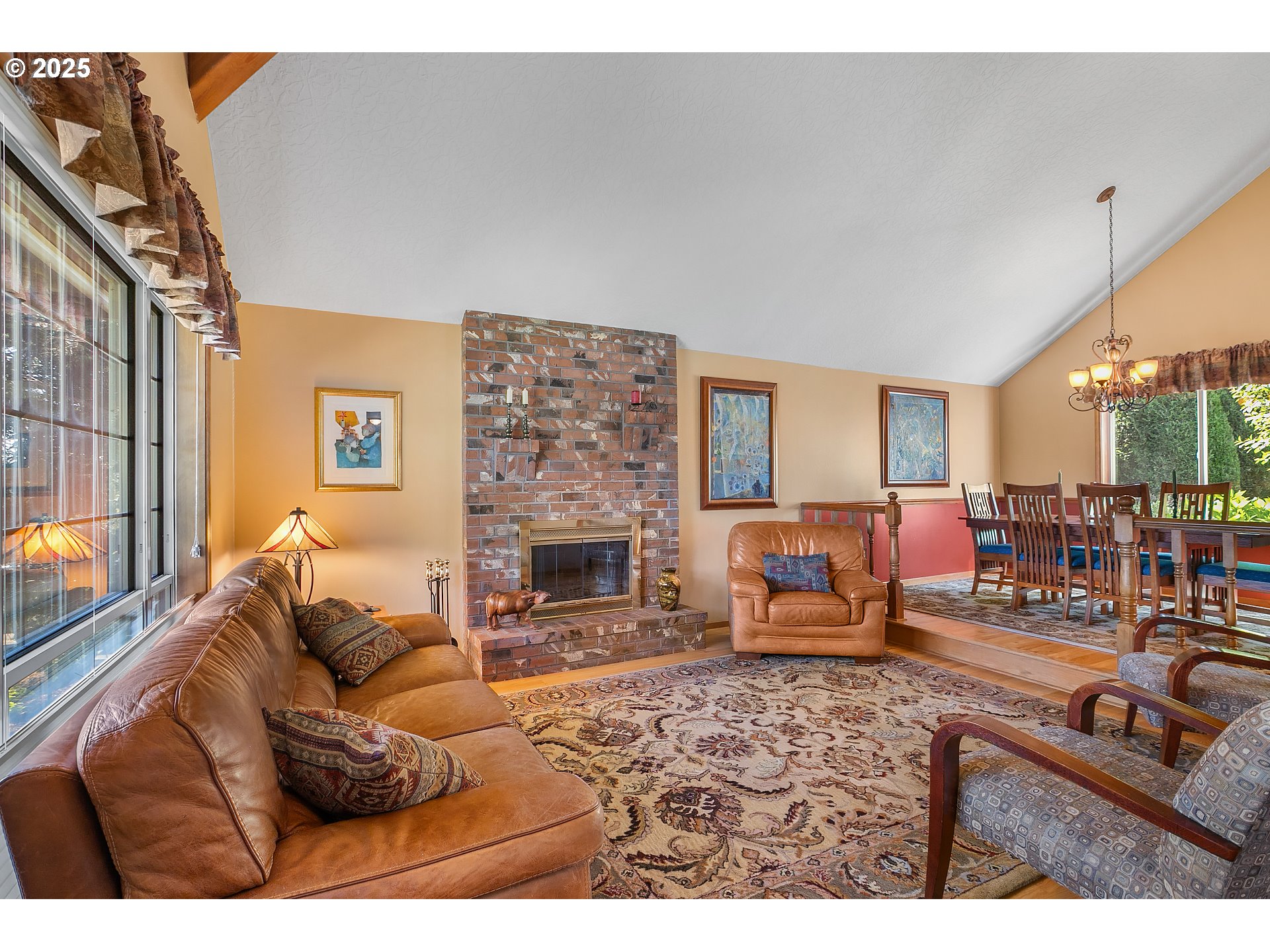 3003 Northeast 164th Street Ridgefield, WA 98642 - Photo 14 of 38 a living room with furniture a fireplace and a flat screen tv