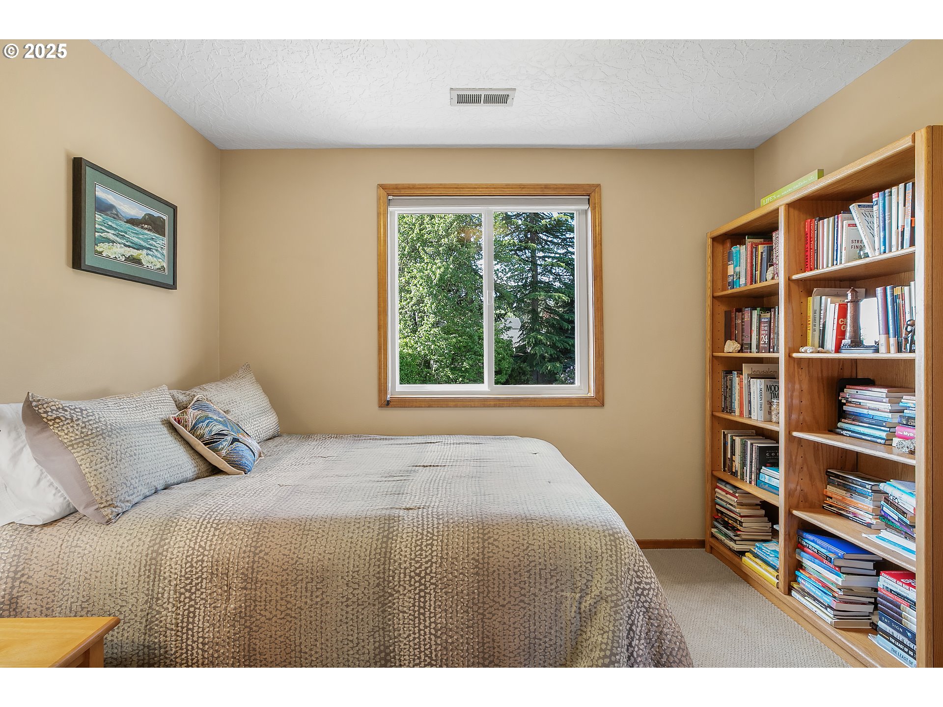 3003 Northeast 164th Street Ridgefield, WA 98642 - Photo 27 of 38 a bedroom with a bed and a book shelf