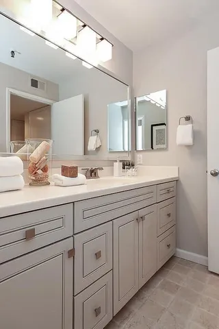 a bathroom with double sink and a mirror