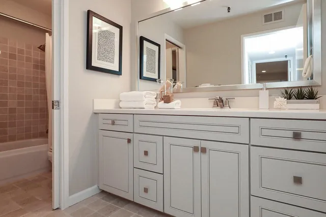 a bathroom with a double vanity sink mirror and