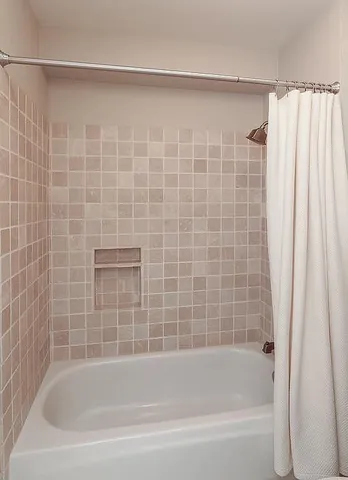 a close up of a bathtub in a shower