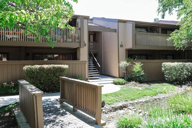a front view of a house with wooden fence