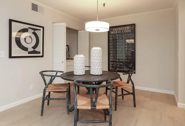 a view of a dining room with furniture and chandelier