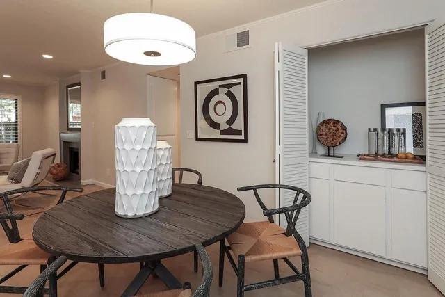 a dining room with furniture and wooden floor