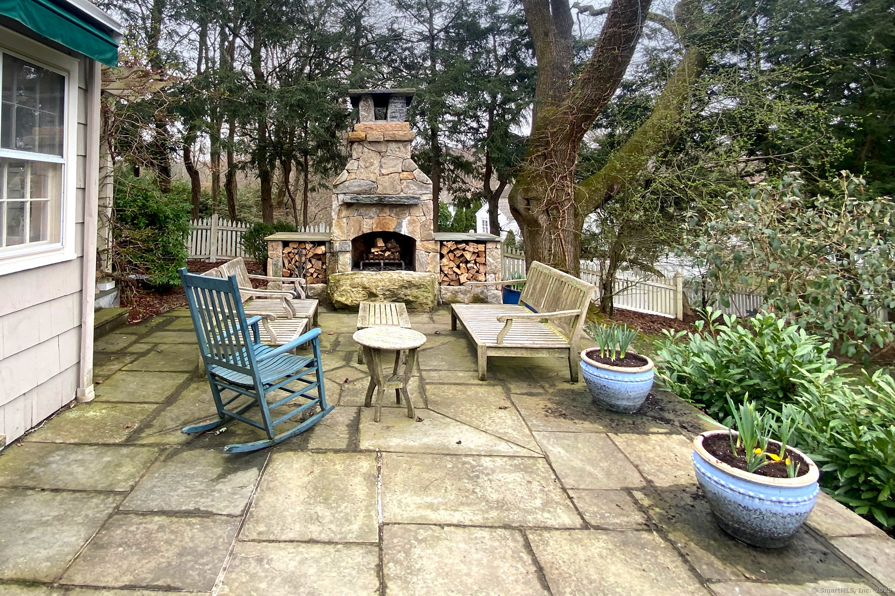 95 Compo Road North Westport, CT 06880 - Photo 24 of 28 a view of a patio with table and chairs potted plants and a fire pit