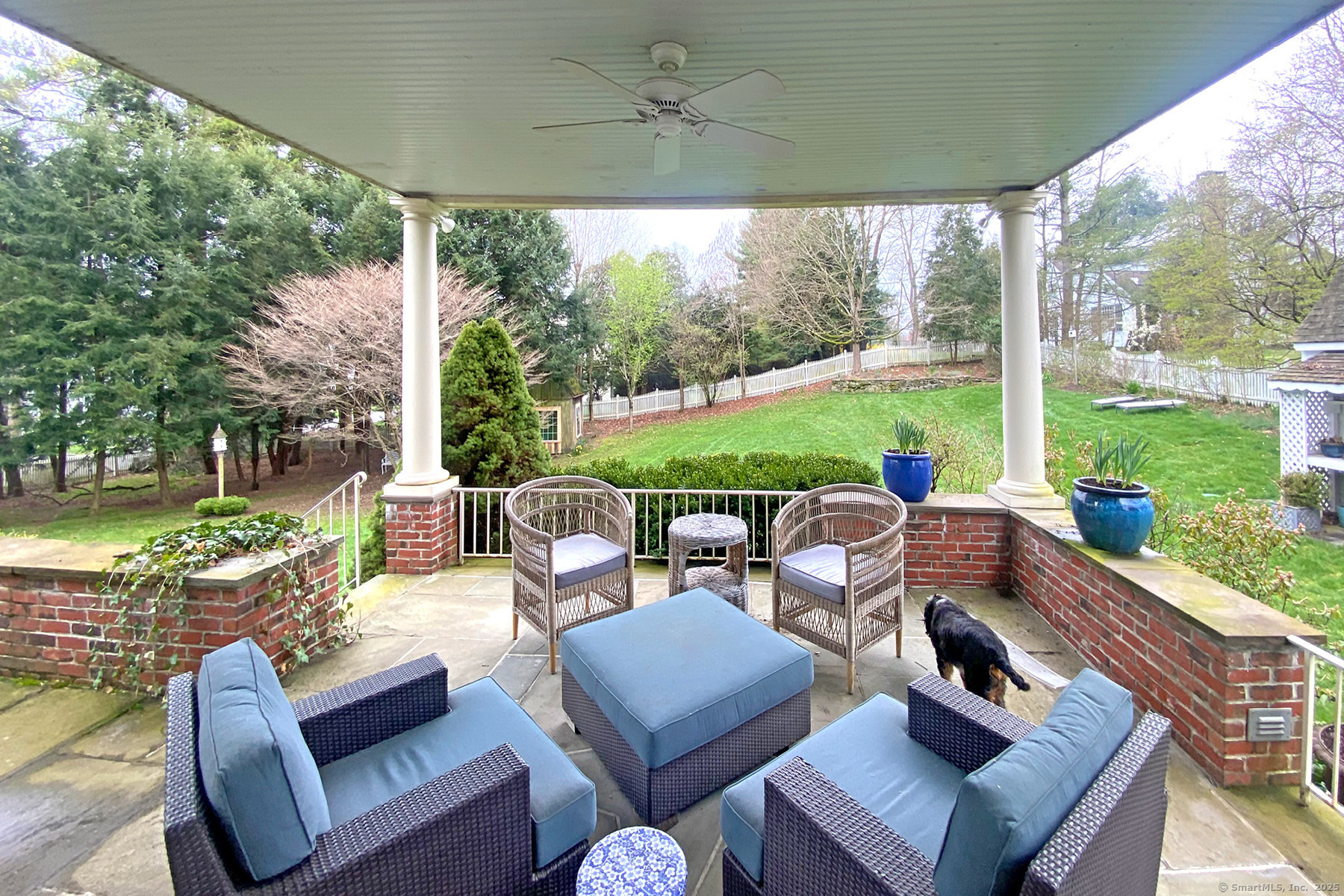 95 Compo Road North Westport, CT 06880 - Photo 5 of 28 a view of a patio with couches chairs and a big yard
