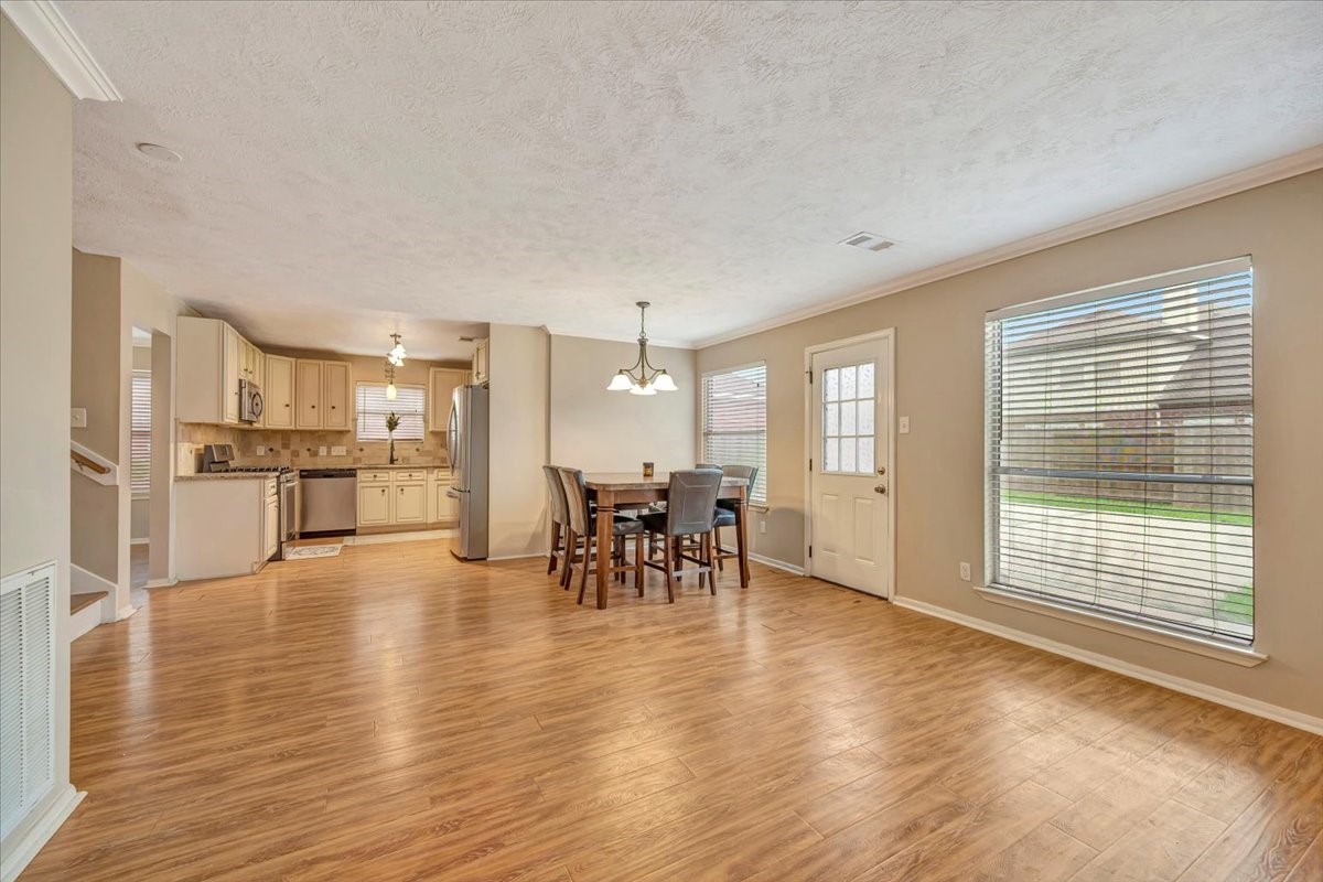 4235 Park Ridge Drive Pasadena, TX 77504 - Photo 14 of 41 a view of a living room and kitchen with furniture floor to ceiling window