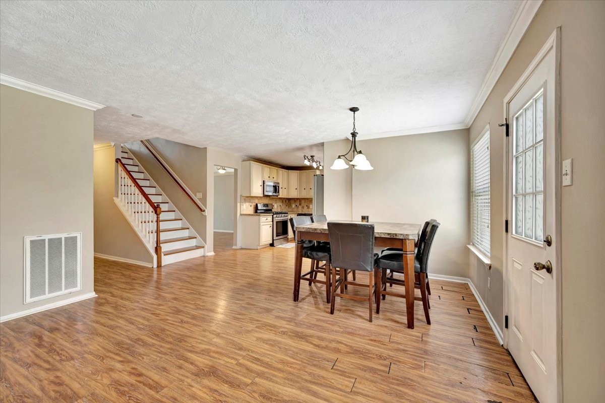 4235 Park Ridge Drive Pasadena, TX 77504 - Photo 15 of 41 a view of a dining room with furniture and wooden floor