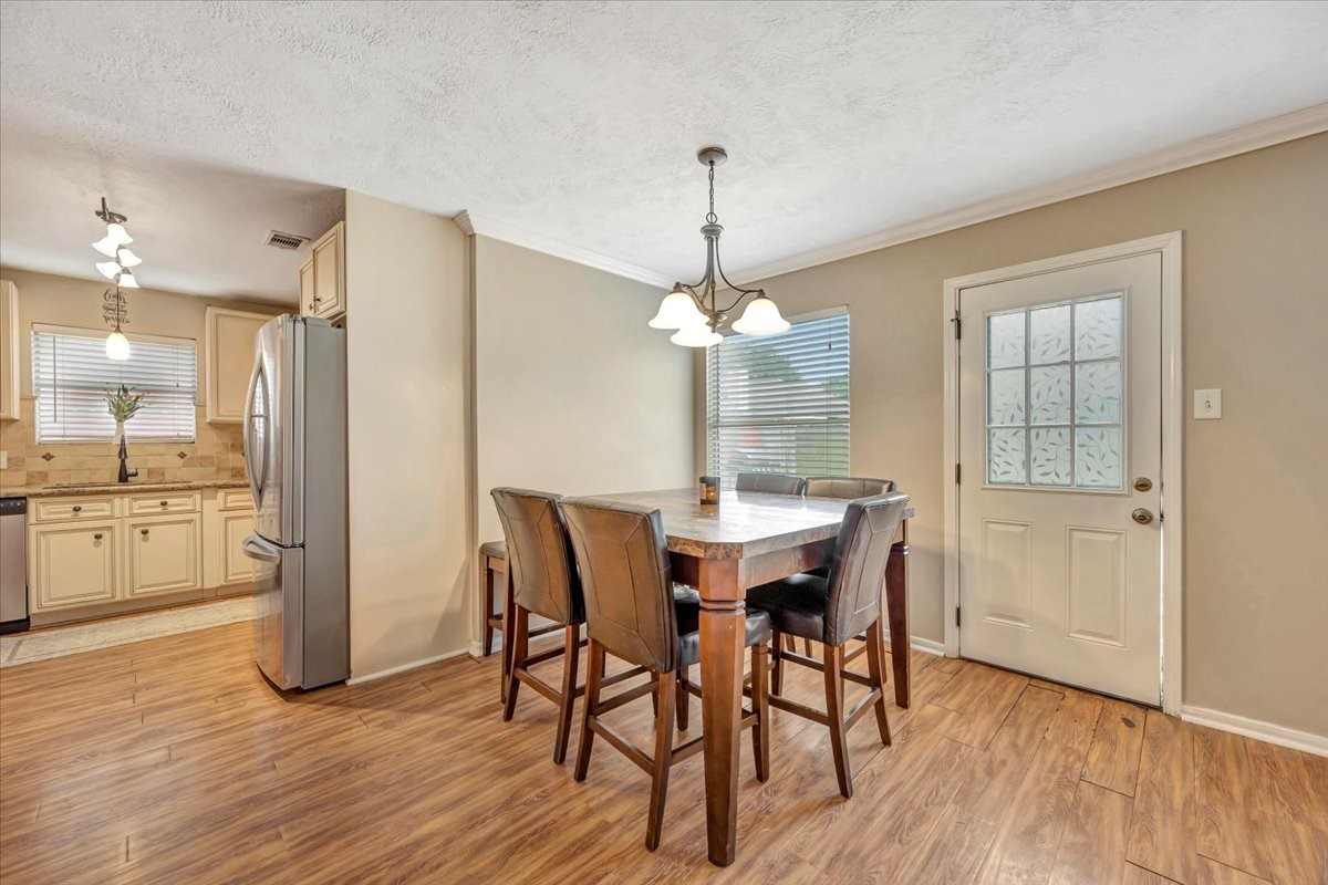 4235 Park Ridge Drive Pasadena, TX 77504 - Photo 16 of 41 a view of a dining room with furniture window and wooden floor