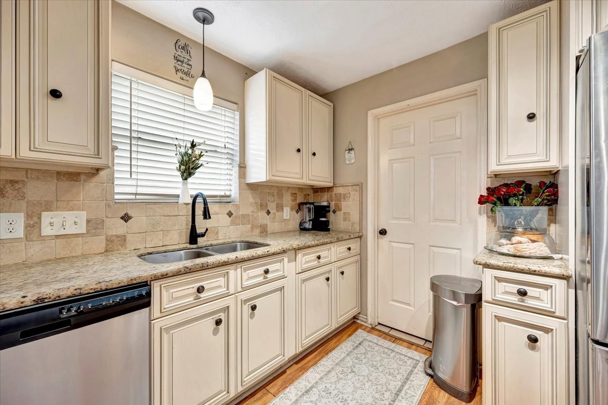 4235 Park Ridge Drive Pasadena, TX 77504 - Photo 20 of 41 a kitchen with stainless steel appliances granite countertop a sink and dishwasher a refrigerator with wooden cabinets