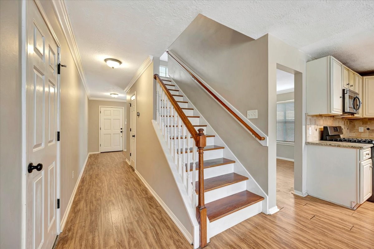 4235 Park Ridge Drive Pasadena, TX 77504 - Photo 23 of 41 a view of a hallway with wooden floor and staircase
