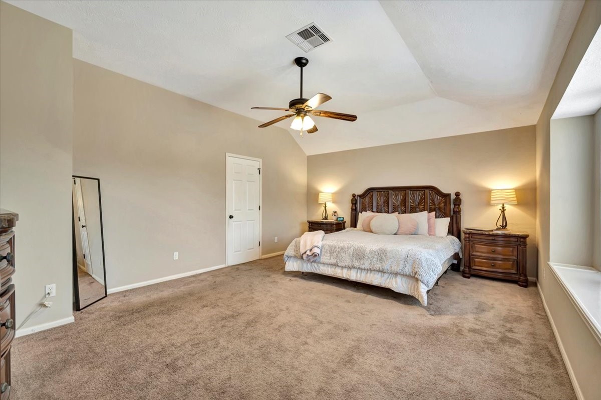 4235 Park Ridge Drive Pasadena, TX 77504 - Photo 29 of 41 a bedroom with a bed and a chandelier