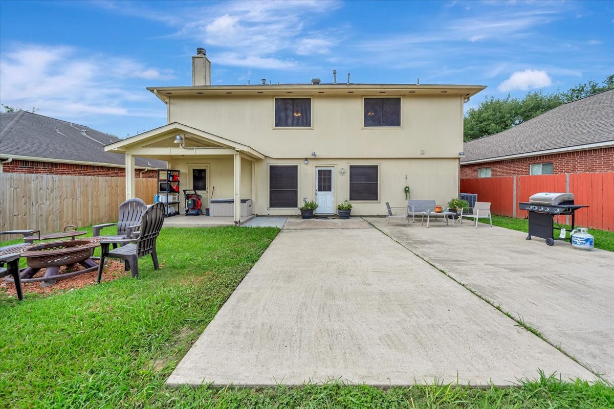 4235 Park Ridge Drive Pasadena, TX 77504 - Photo 6 of 41 a view of a white house with a patio and a yard