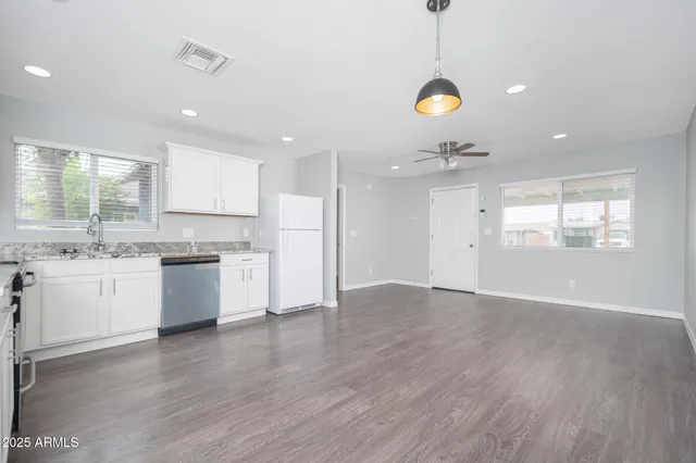 a kitchen with a refrigerator and window