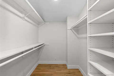 a view of a room with furniture and wooden floor
