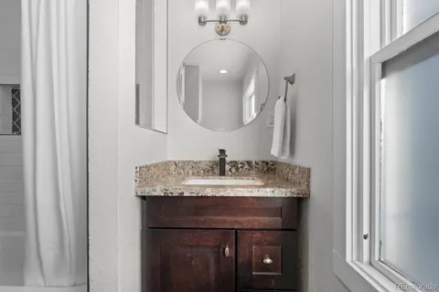 a living room with a bed and a window