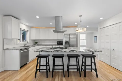a kitchen with cabinets table and chairs