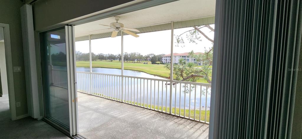 6554 Fairway Gardens Drive, Unit 6554 Bradenton, FL 34203 - Photo 19 of 25 a view of a room with wooden floor and floor to ceiling window