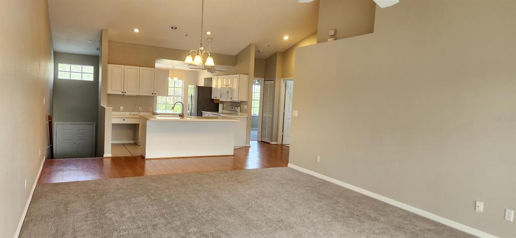 6554 Fairway Gardens Drive, Unit 6554 Bradenton, FL 34203 - Photo 2 of 25 a view of a kitchen and a refrigerator in a kitchen