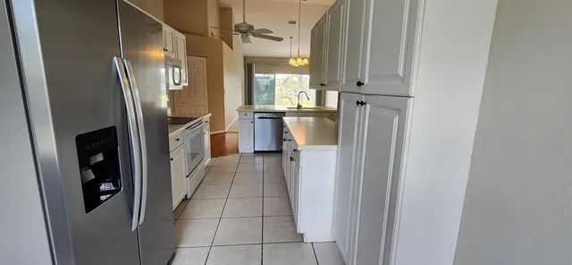 a kitchen with stainless steel appliances a refrigerator and a stove
