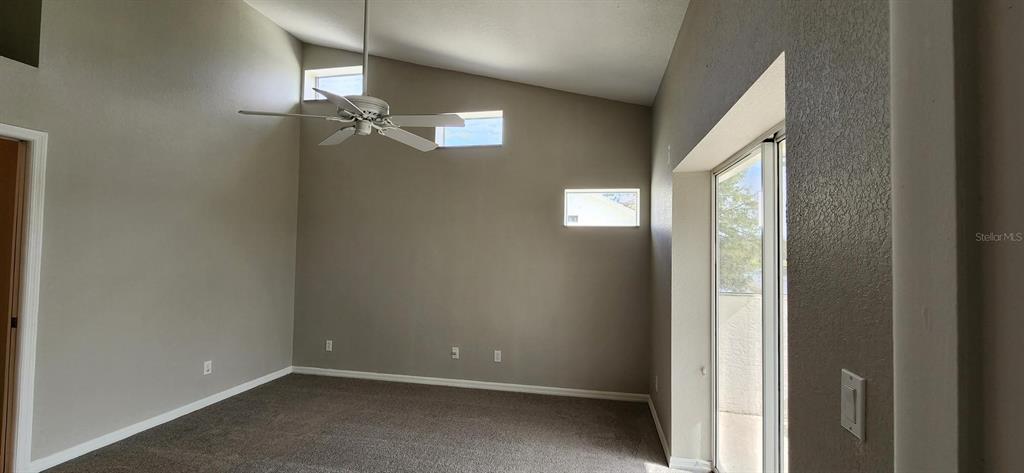 6554 Fairway Gardens Drive, Unit 6554 Bradenton, FL 34203 - Photo 7 of 25 an empty room with windows and fan
