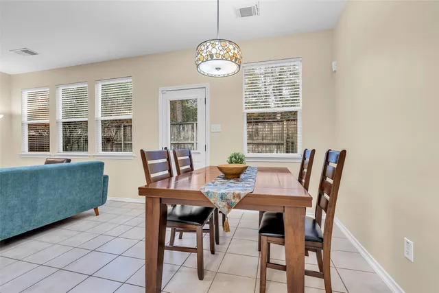 a view of a dining room with furniture large windows and wooden floor