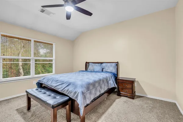 a bedroom with a bed and a large window