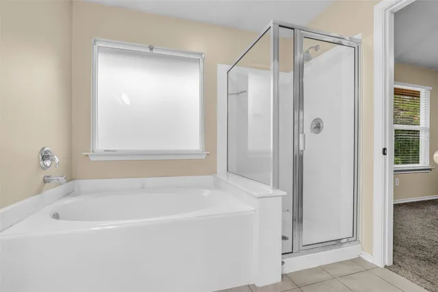 a white bath tub sitting next to a shower
