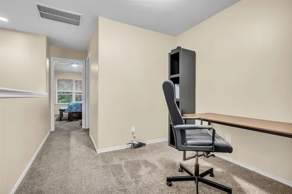 a view of a workspace with furniture and windows