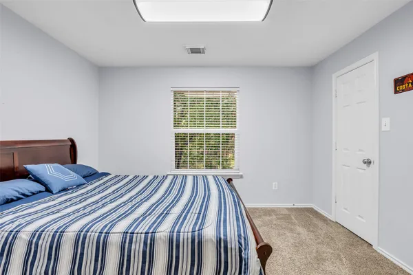 a bedroom with a bed and window