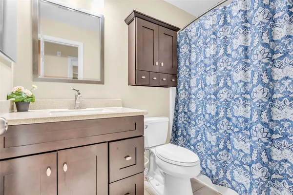 a bathroom with a sink a toilet and mirror