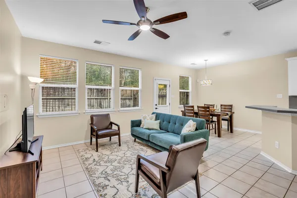 a living room with furniture and a dining table