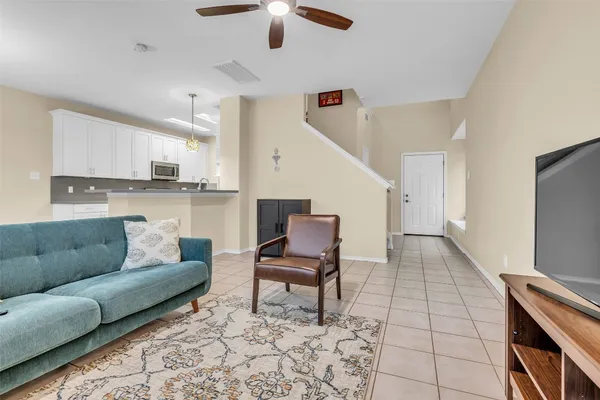 a living room with furniture and kitchen view