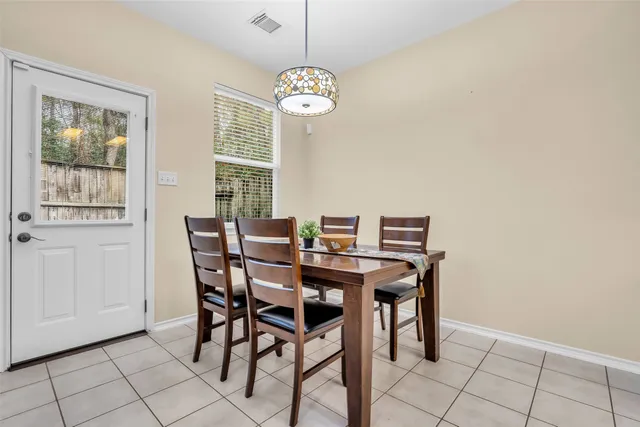 a view of a dining room with furniture and chandelier