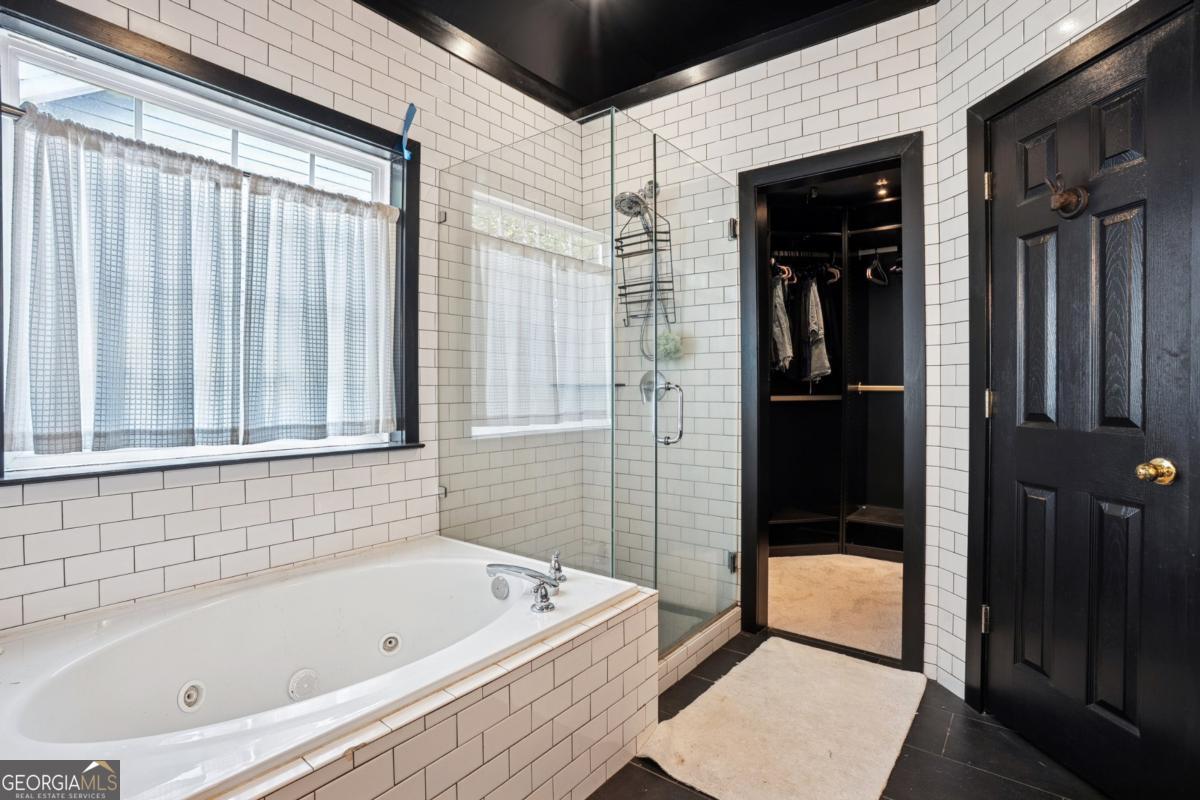 1229 Crescentwood Lane Decatur, GA 30032 - Photo 18 of 25 a bathroom with a bathtub and a shower