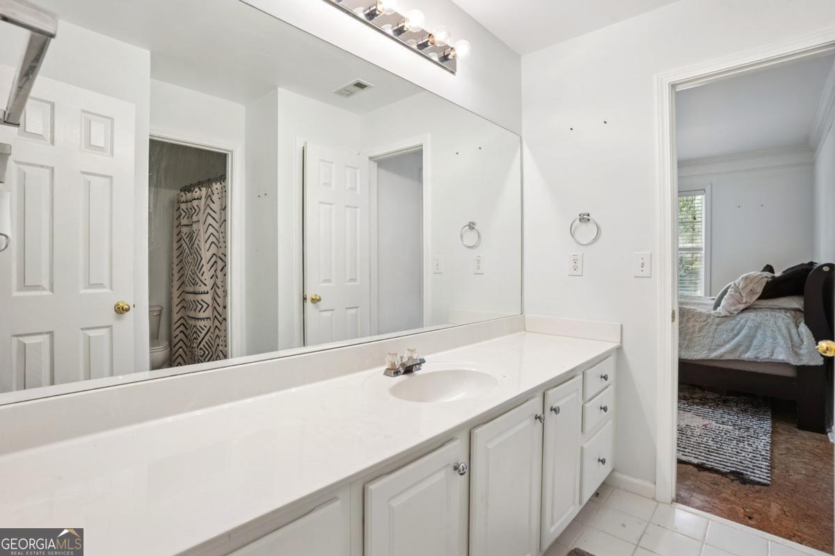 1229 Crescentwood Lane Decatur, GA 30032 - Photo 20 of 25 a en suite bathroom with a sink and a mirror